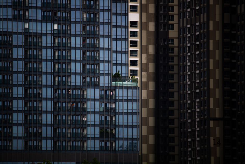 Modern skyscraper facade featuring a terrace amid urban architecture.
