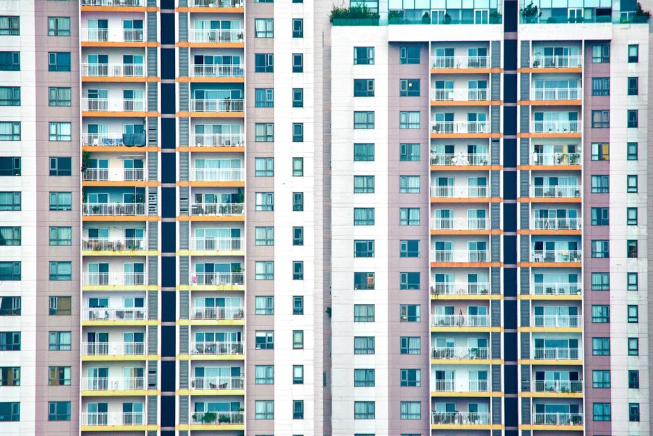 Clear view of a modern high-rise apartment building showcasing multiple balconies.